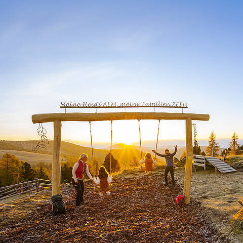 ZEITplatz mit Panoramaschaukel  im warmen Licht der untergehenden Sonne in den Nockbergen.